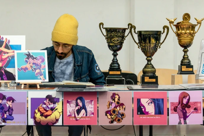 un artiste (hawax) qui a créer des trophées et un stand de poster pendant un tournoi